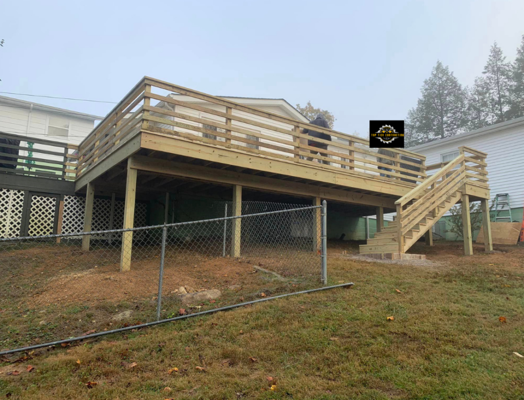 Wooden deck on back side of house with railing and stairs