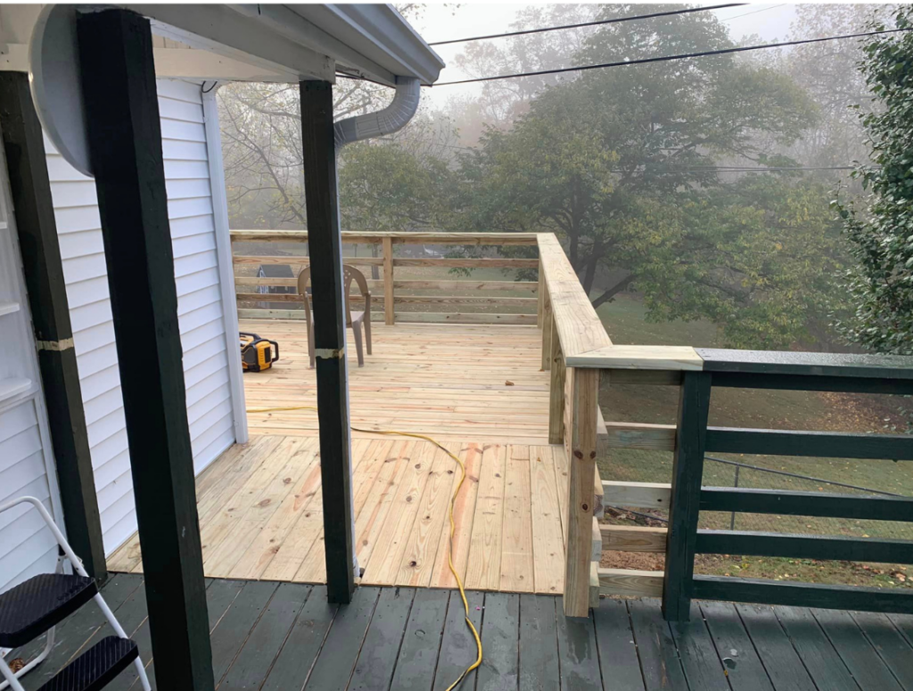 Wooden deck addition ties in to existing deck