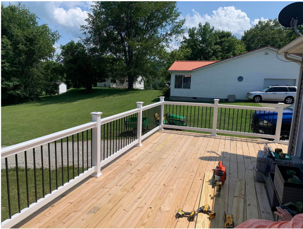 Two tone wooden deck with light brown floor and white banister